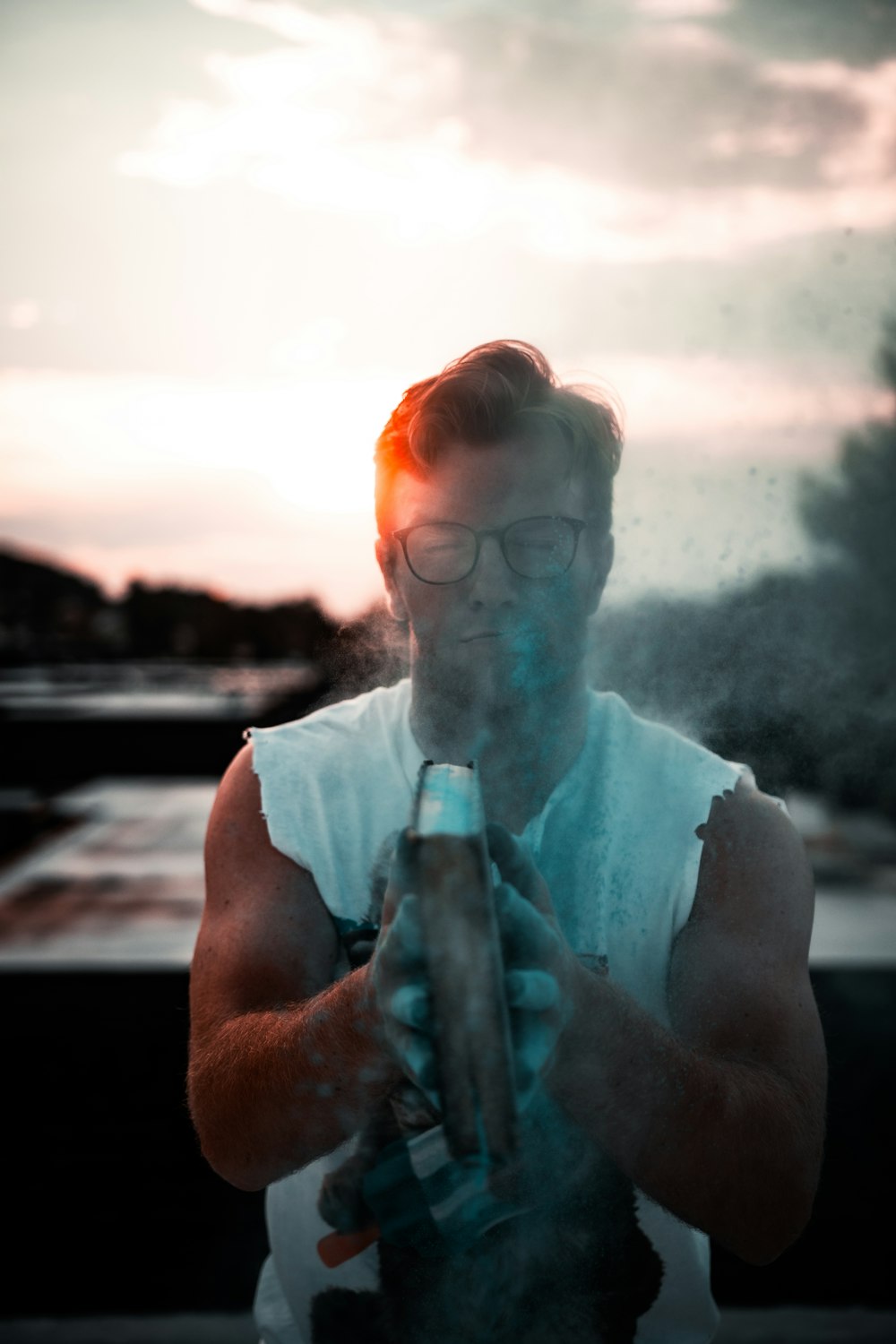 man in white crew neck t-shirt smoking cigarette