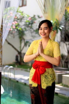 woman in yellow and red floral dress holding umbrella