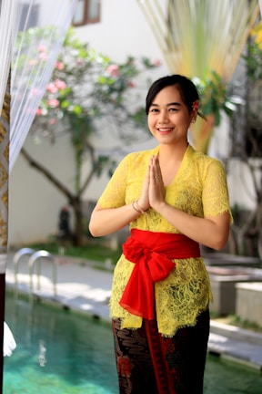 Smiling business owner Yasmin da Trindade Lobao greeting clients warmly.