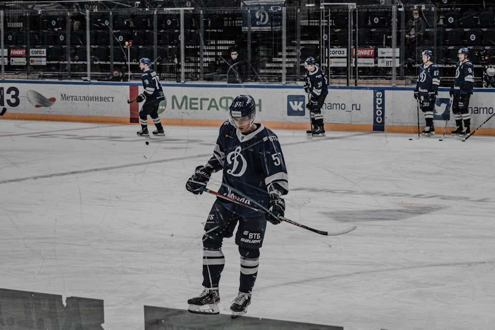 man in black ice hockey jersey playing hockey