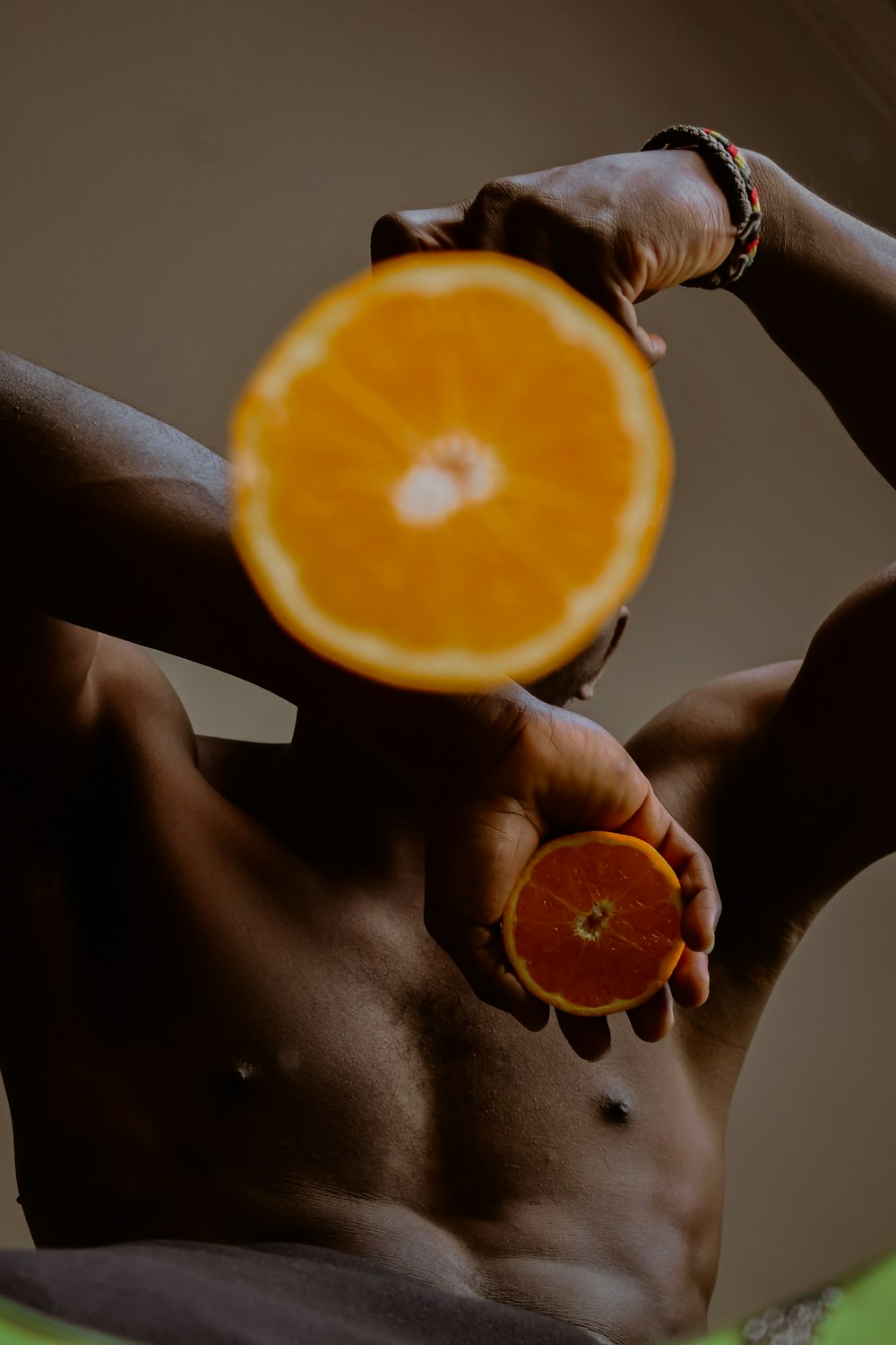 person holding sliced orange fruit