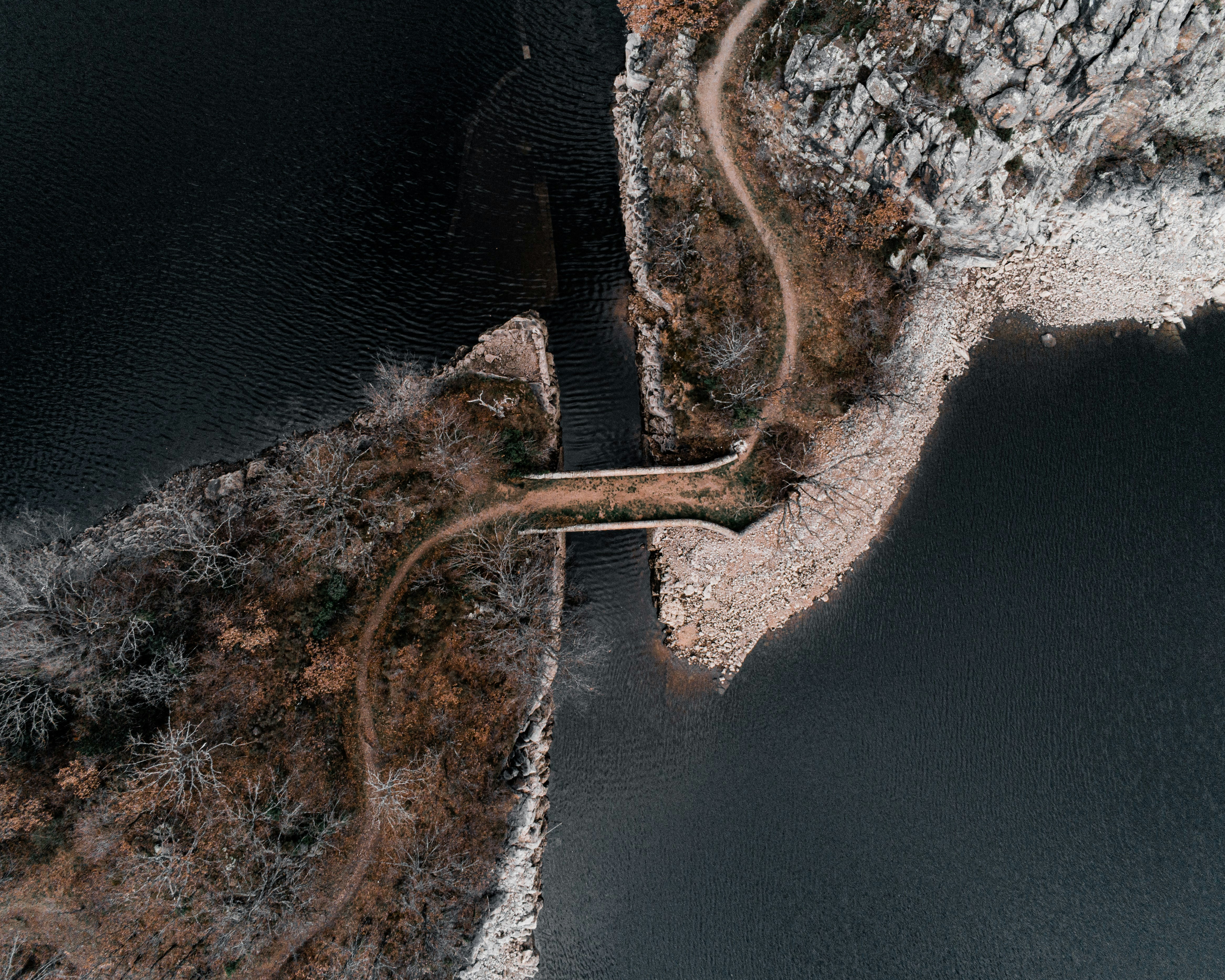 aerial view of brown wooden dock on body of water during daytime
