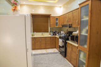 Modern home kitchen with various electrical appliances neatly arranged.