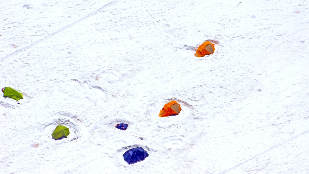 blue orange and yellow balloons on snow covered ground