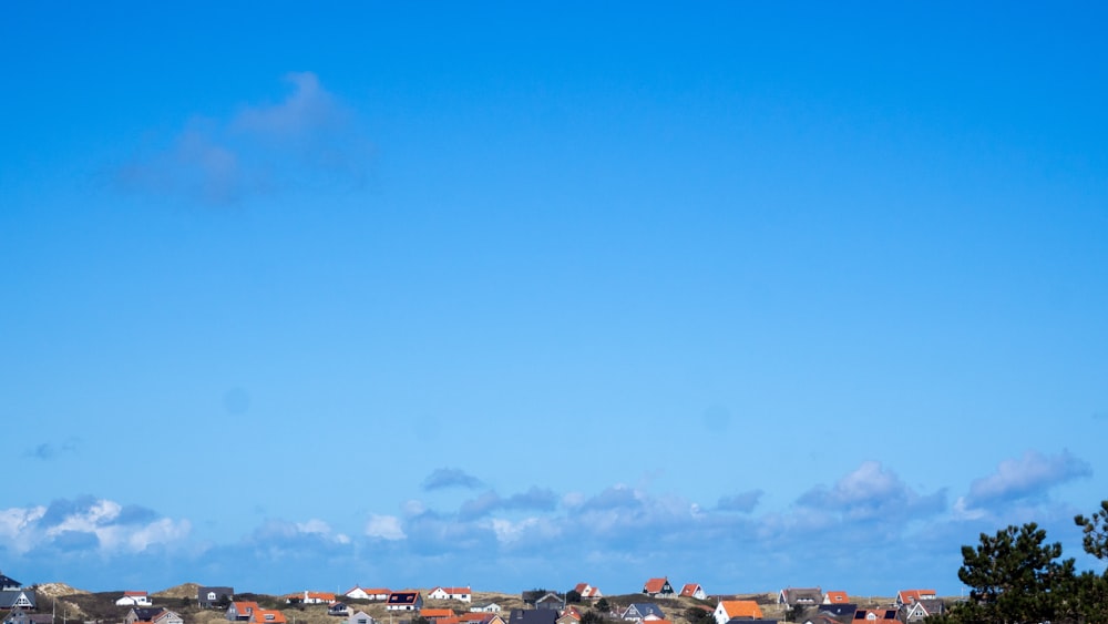 white and brown houses under blue sky during daytime