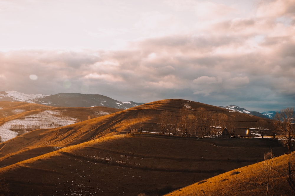 brown and gray mountains under white cloudy sky during daytime