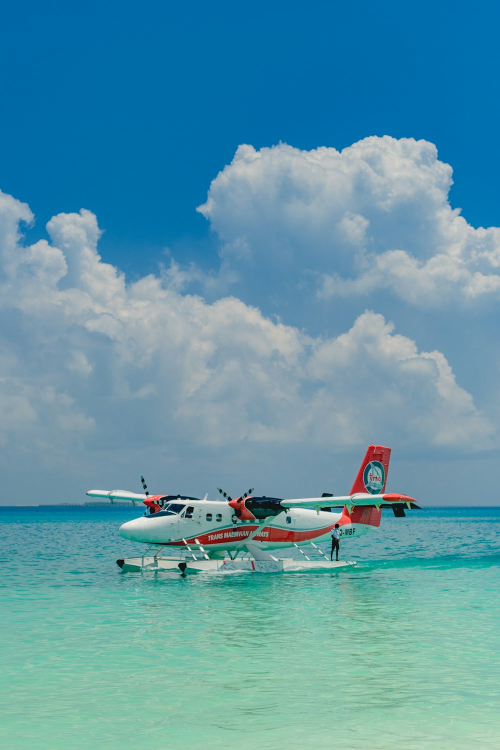 white and red plane on the sky during daytime