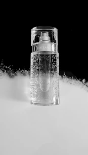 Close-up of a stylish perfume bottle with a modern design on a clean white background