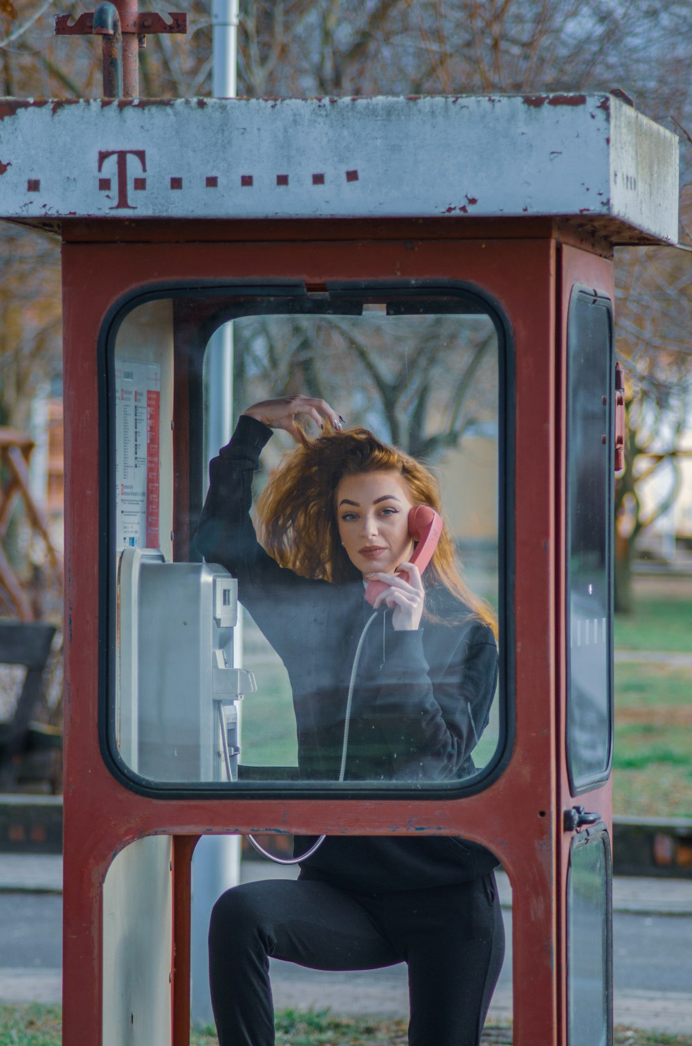 woman in white long sleeve shirt in red train