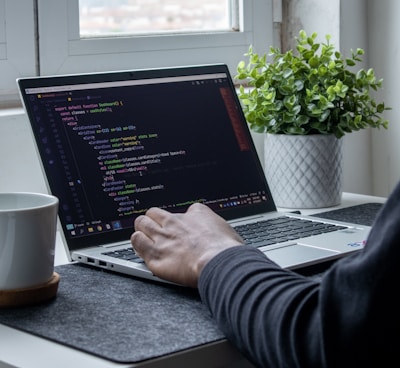 person using macbook pro on table