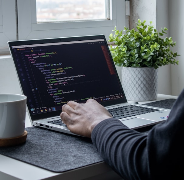 person using macbook pro on table