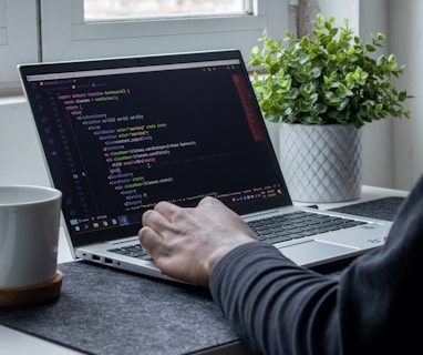 person using macbook pro on table