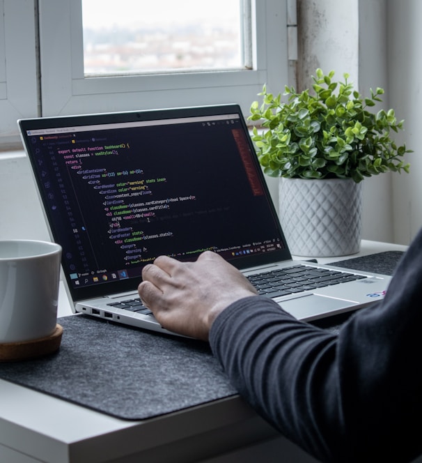 person using macbook pro on table