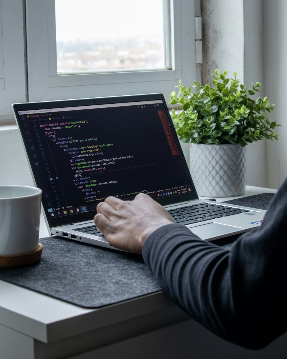 person using macbook pro on table