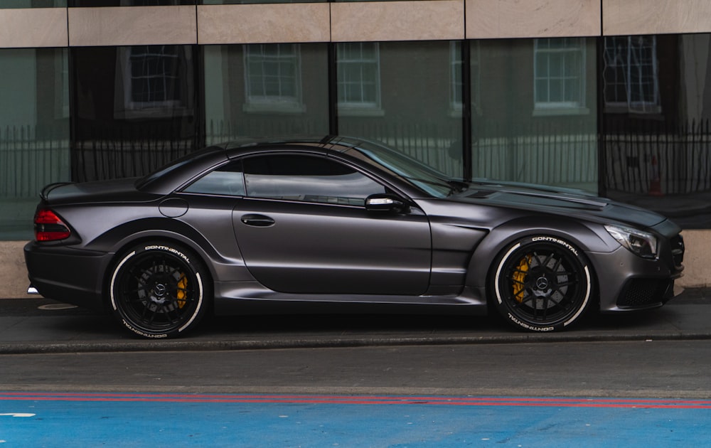 black coupe parked beside building