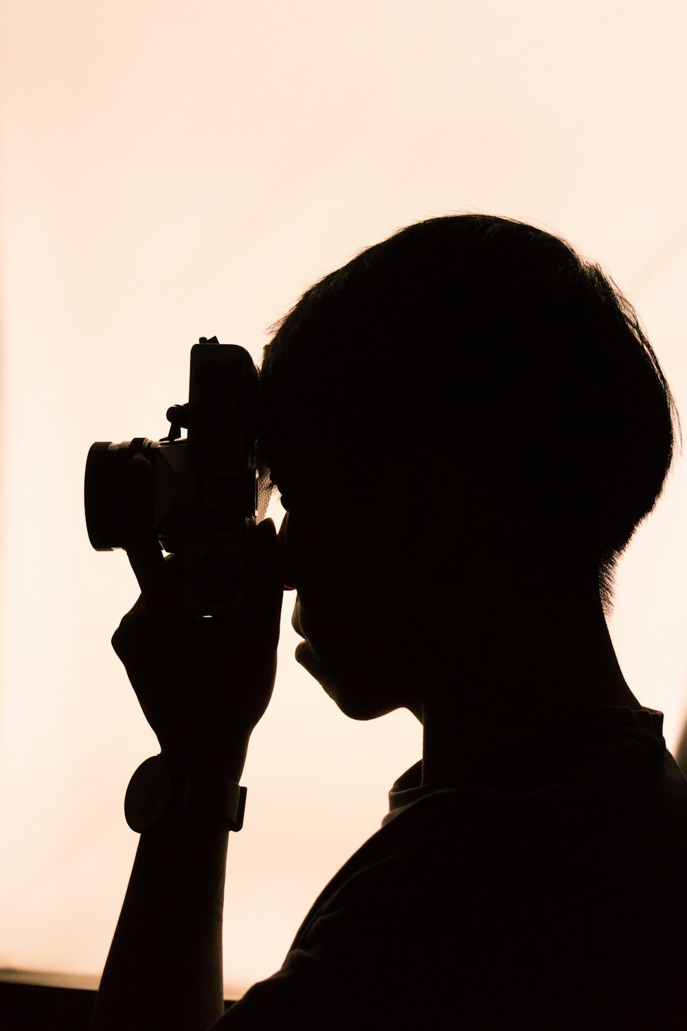 silhouette of man holding camera