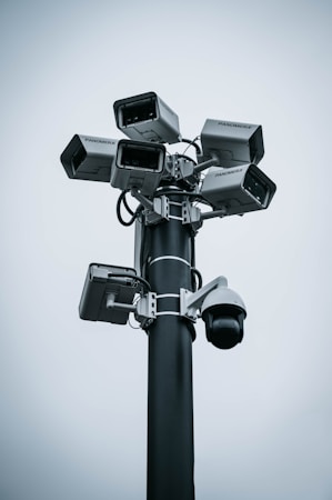 Multiple surveillance cameras mounted on a tall pole above a roadway, similar to license plate reader installations used across Southern Nevada