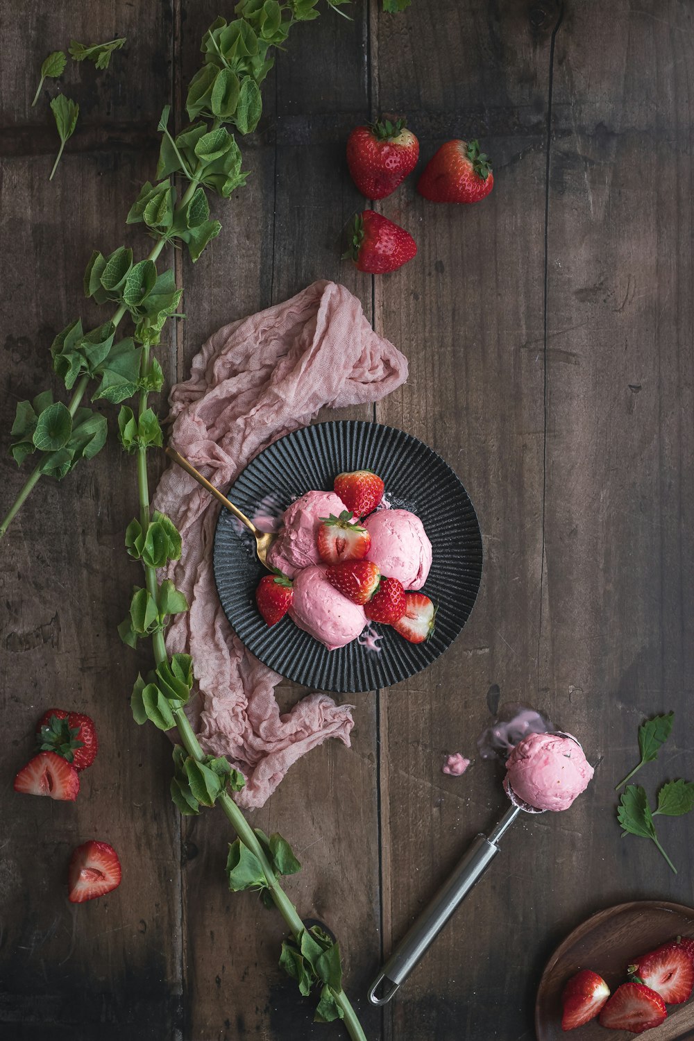 red strawberries on black ceramic bowl