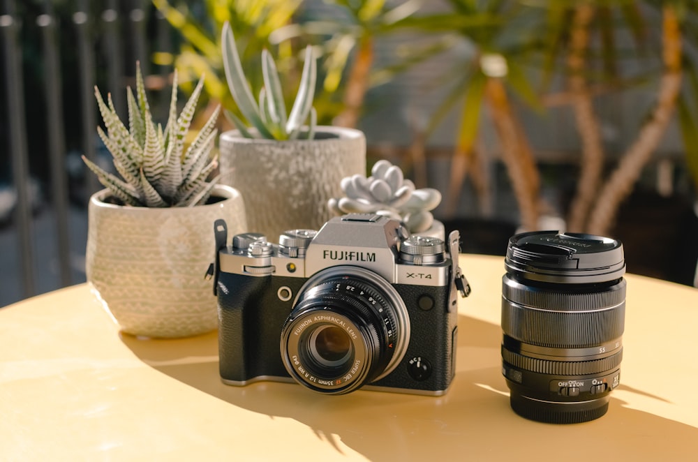 black and silver nikon dslr camera on white table