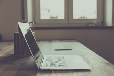 macbook pro on brown wooden table