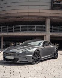 grey mercedes benz coupe parked on grey concrete pavement during daytime