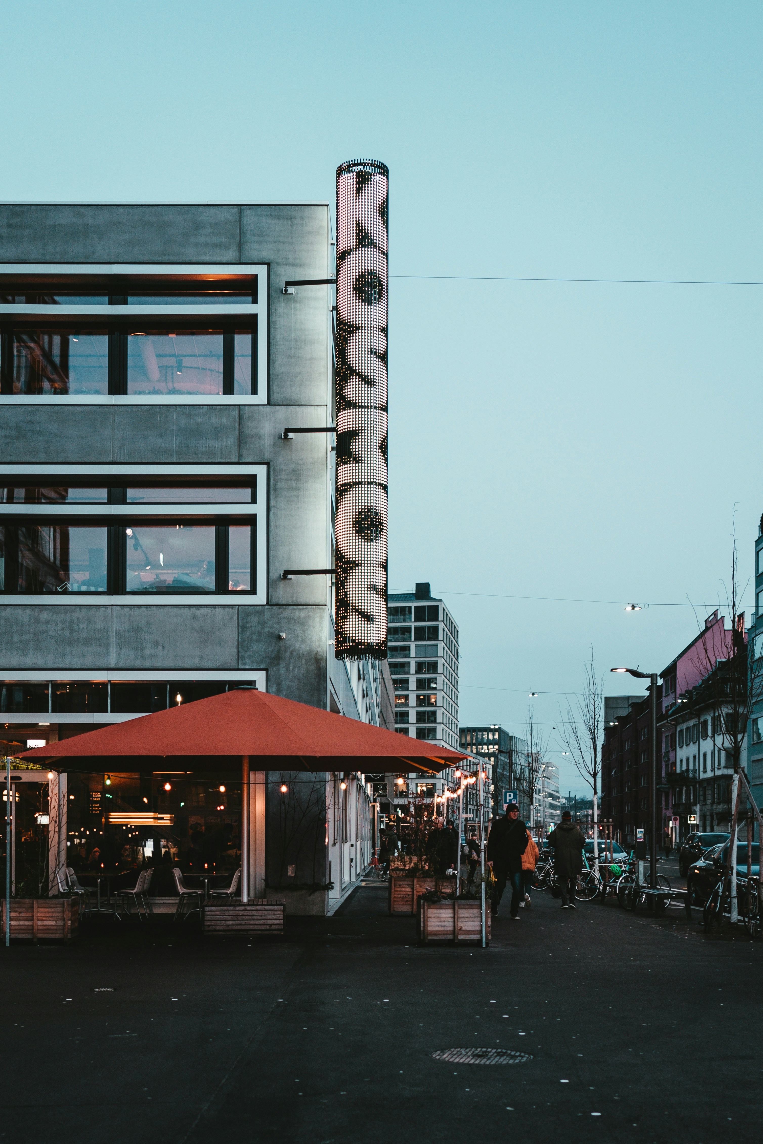 people walking on sidewalk near building during daytime