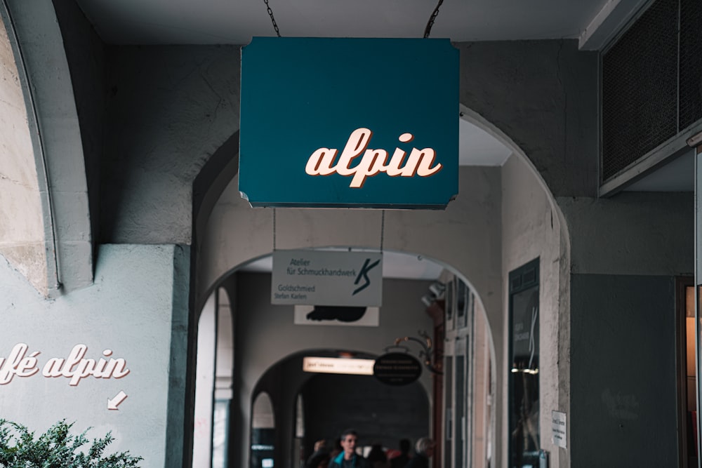 a sign hanging from the side of a building