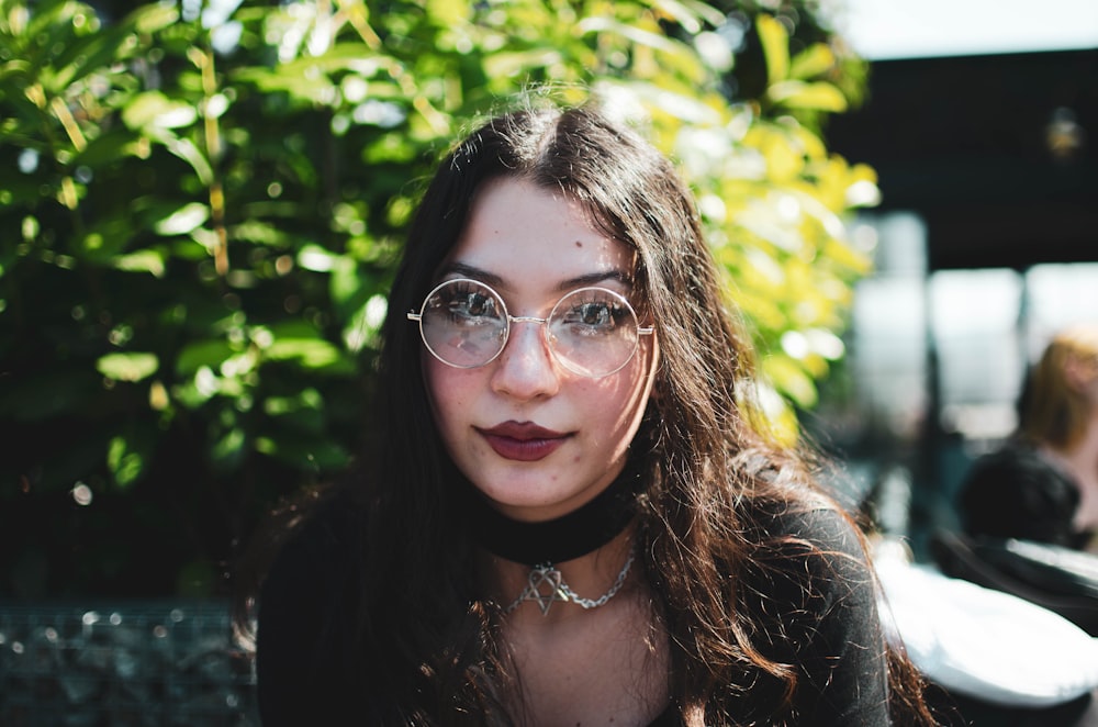 woman in black framed eyeglasses smiling