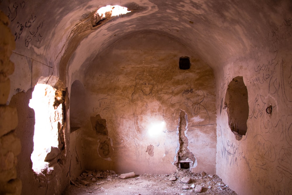 person in black jacket standing inside tunnel