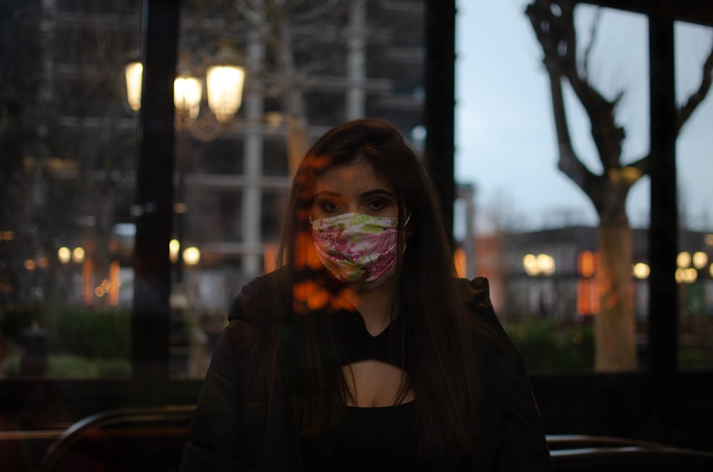 woman in black long sleeve shirt with white mask