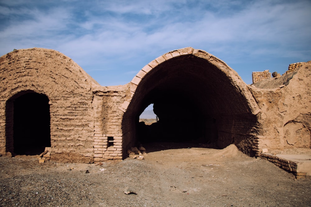 brown concrete arch under blue sky during daytime