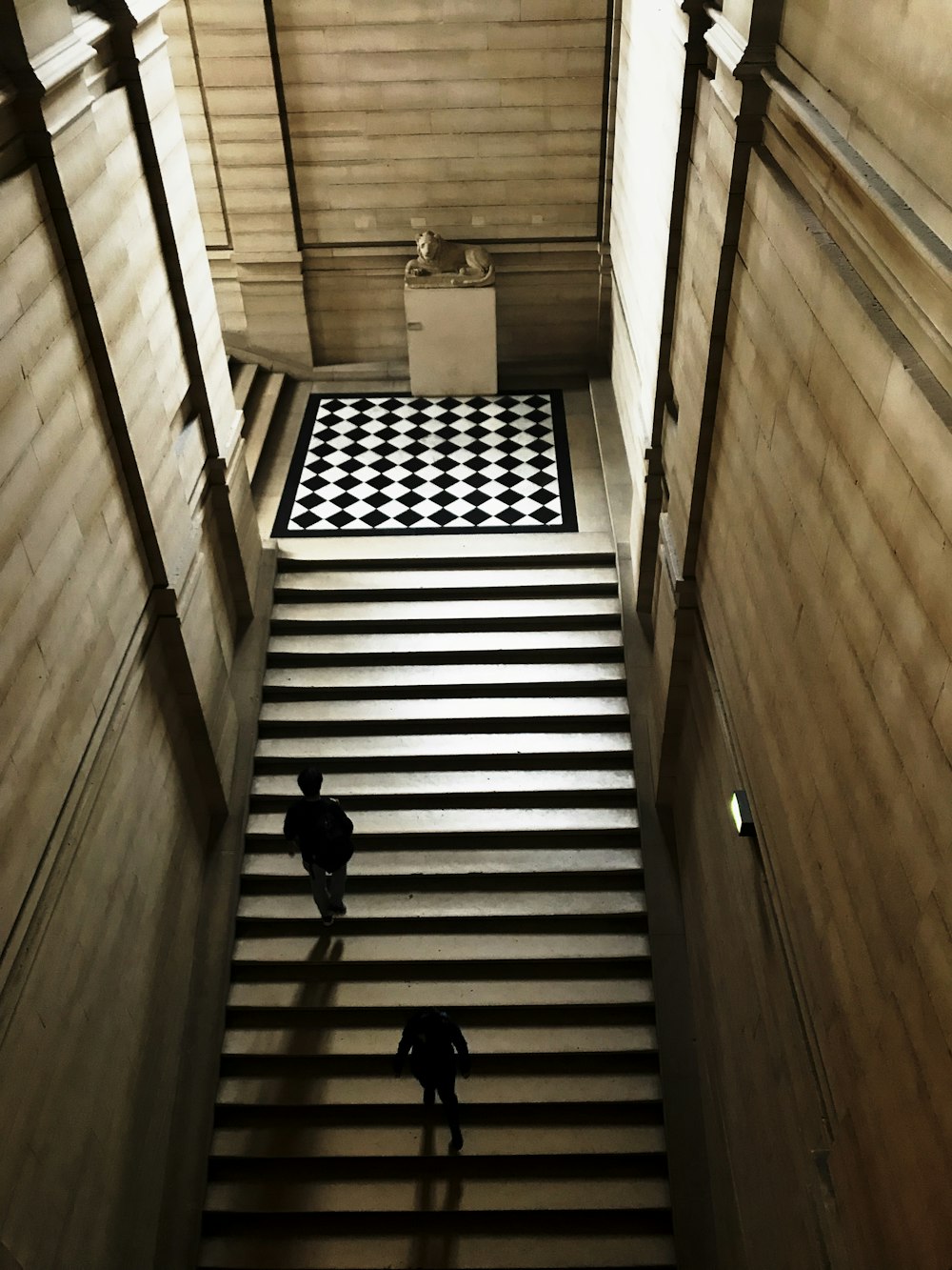 people walking on brown wooden staircase