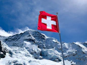 red flag on top of snow covered mountain