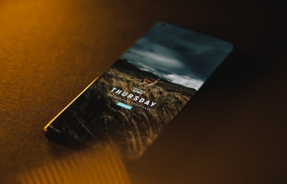 black android smartphone on brown wooden table