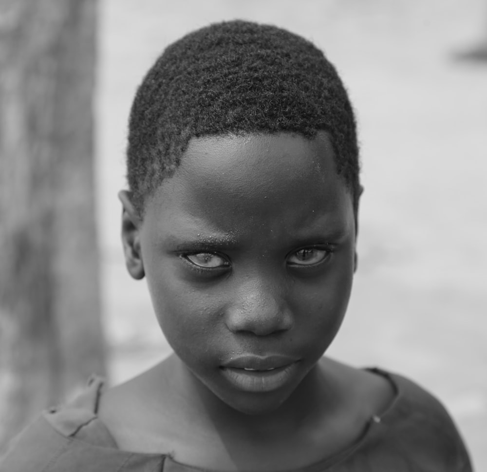 grayscale photo of boy in crew neck shirt