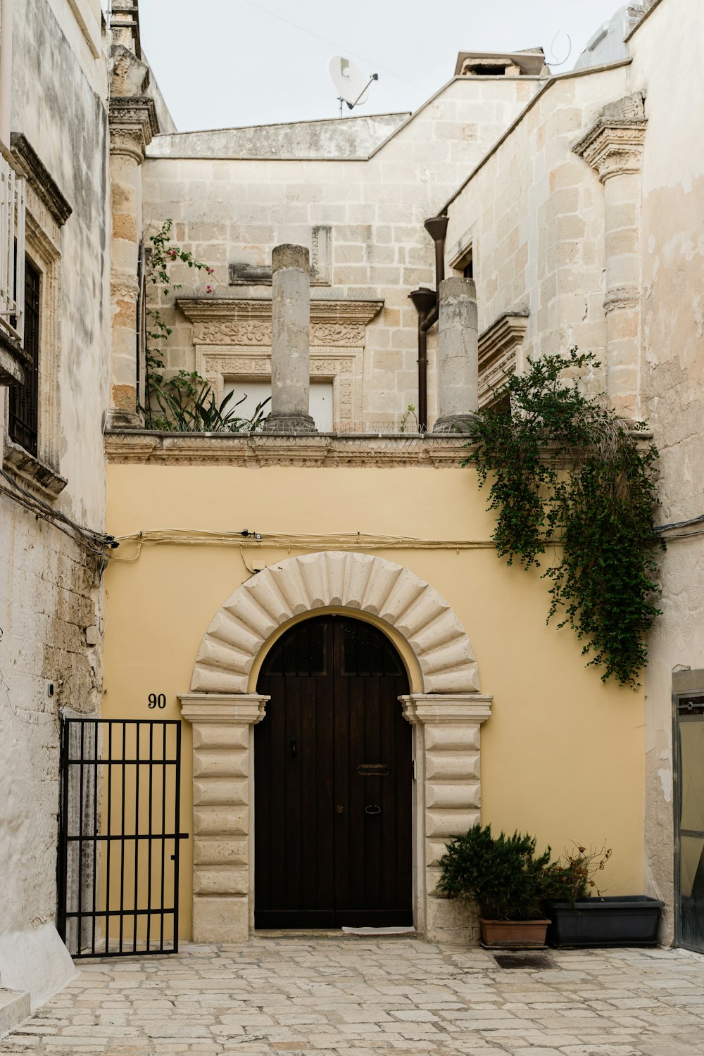 black metal gate on white concrete building