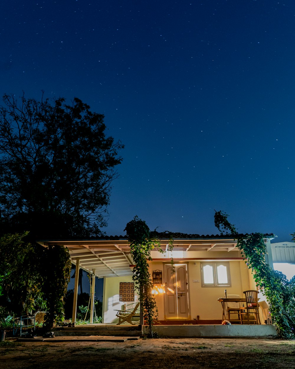 white and brown house under blue sky during night time