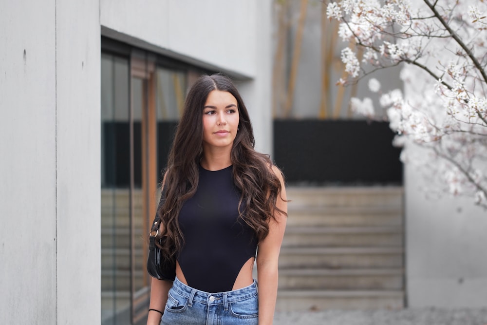 woman in black tank top and blue denim shorts