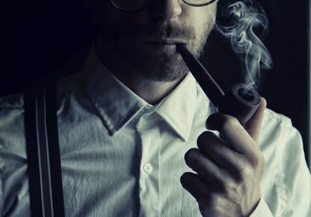 man in white dress shirt smoking