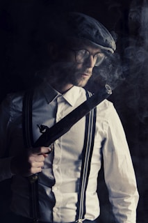 man in white dress shirt wearing black necktie and black sunglasses