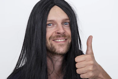 A black and white portrait of a satisfied client giving a thumbs up.