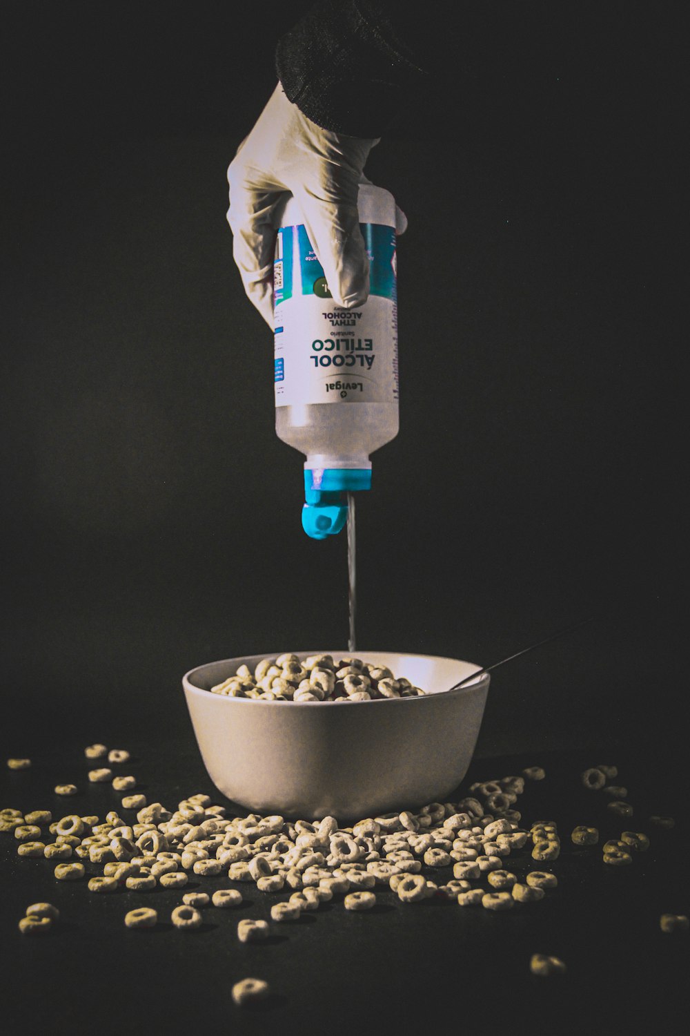 blue and white plastic bottle pouring water on white ceramic bowl