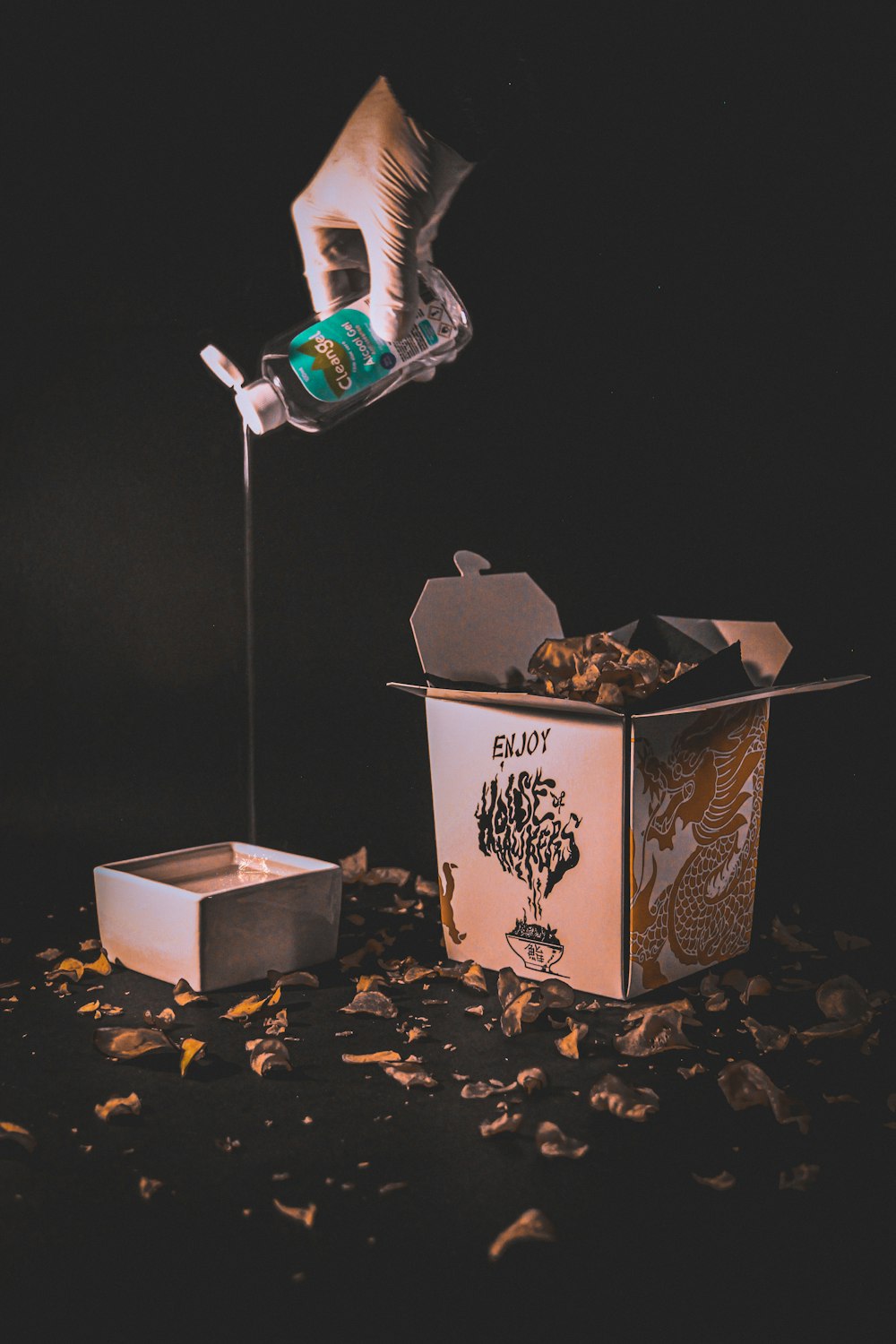 white and black floral box with silver and green bottle