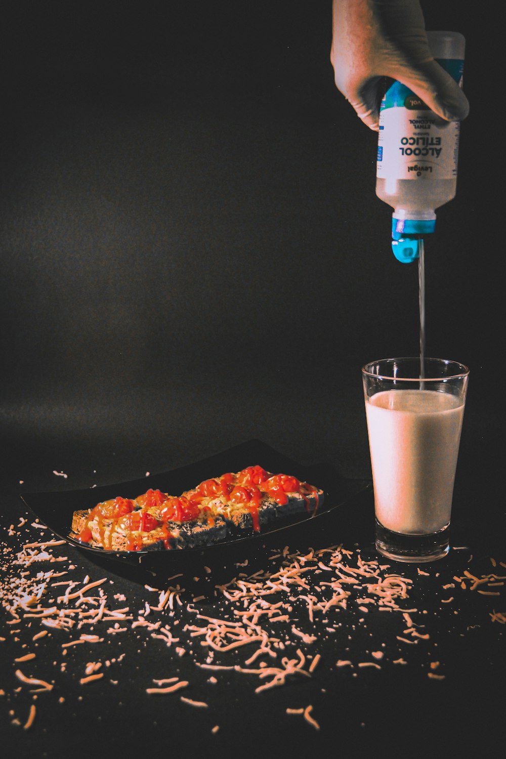 a person pouring milk into a plate of food