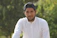 man in white dress shirt and black cap