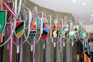 Elegant bronze ceremonial staff resting on deep royal blue velvet, symbolizing the Kosoko royal heritage.