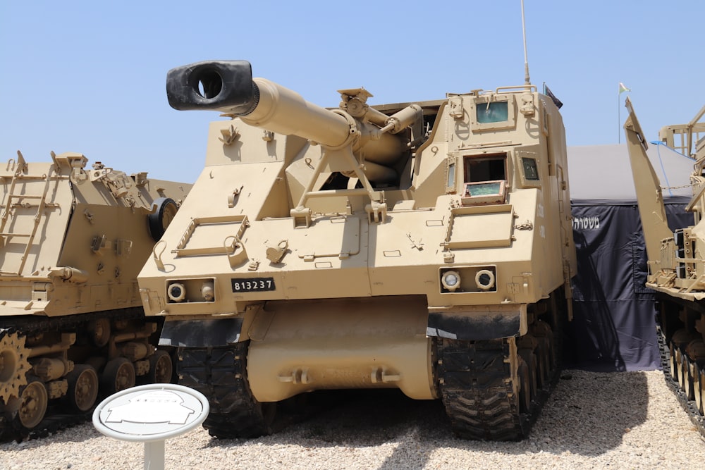 brown battle tank on dirt ground during daytime