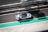 An action shot of a car racing on a track.