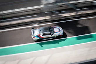 Sleek racing stripes on a sports car speeding down a track.