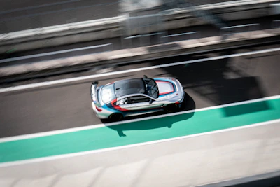Sleek racing stripes on a sports car speeding down a track.